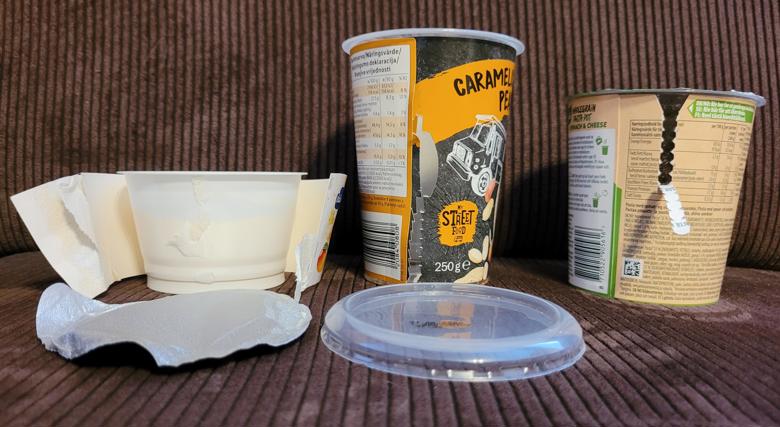 three plastic jars with a cardboard wrapper around them